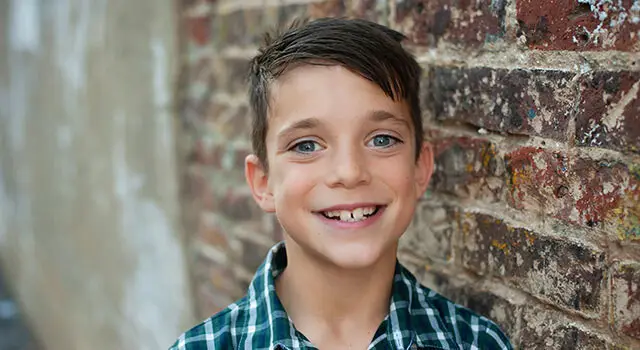 boy smiling for back to school eye exams