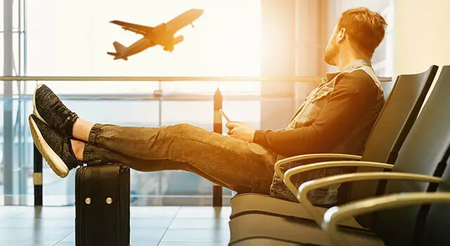 young man waiting at airport gate